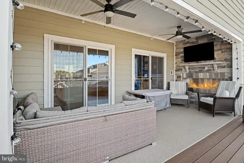 a outdoor space with patio the couches and a flat screen tv