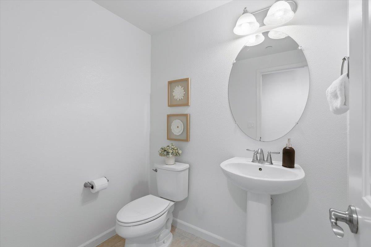 1989 Trento Loop Milpitas, CA 95035 - Photo 13 of 32 a bathroom with a toilet sink and mirror