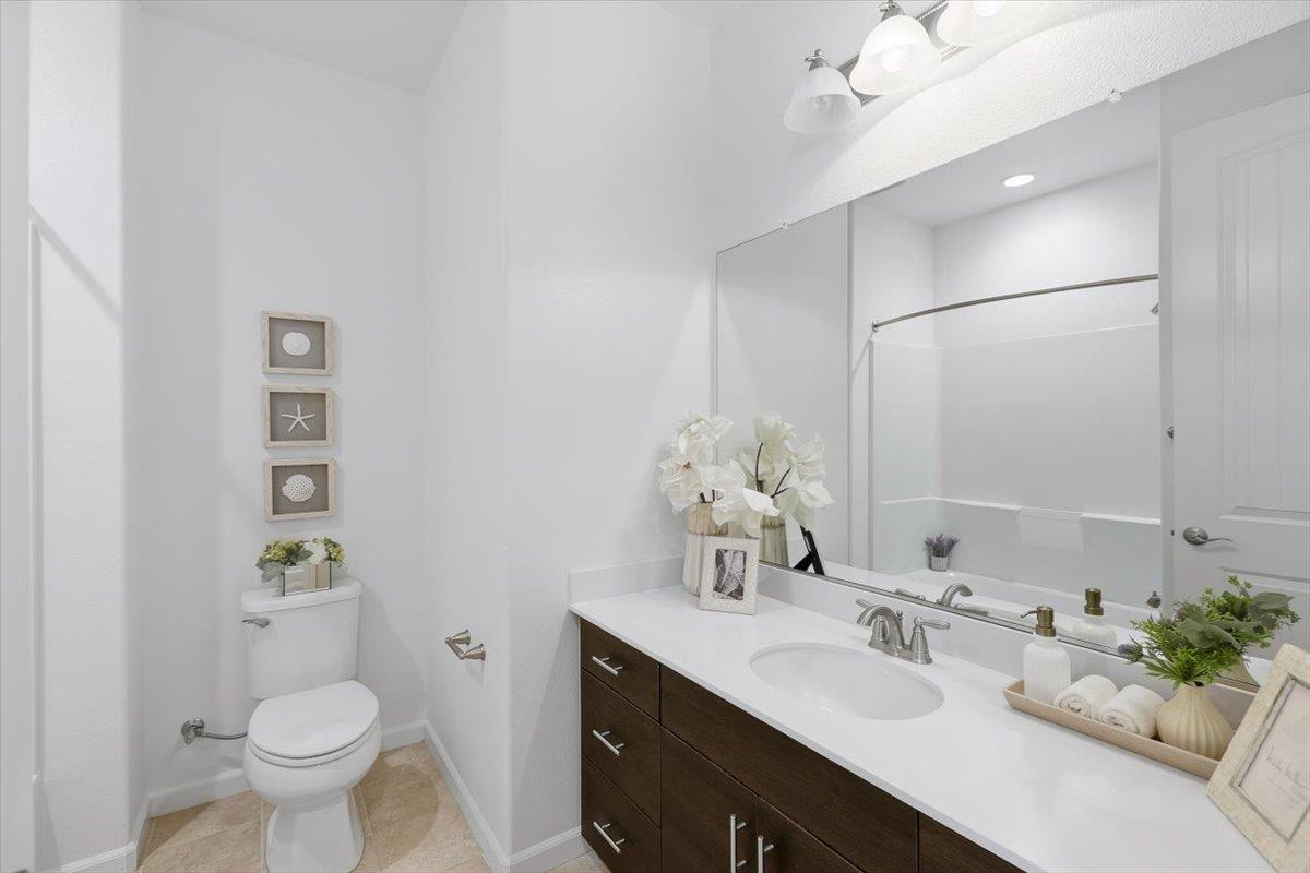 1989 Trento Loop Milpitas, CA 95035 - Photo 14 of 32 a bathroom with a granite countertop sink toilet and a mirror