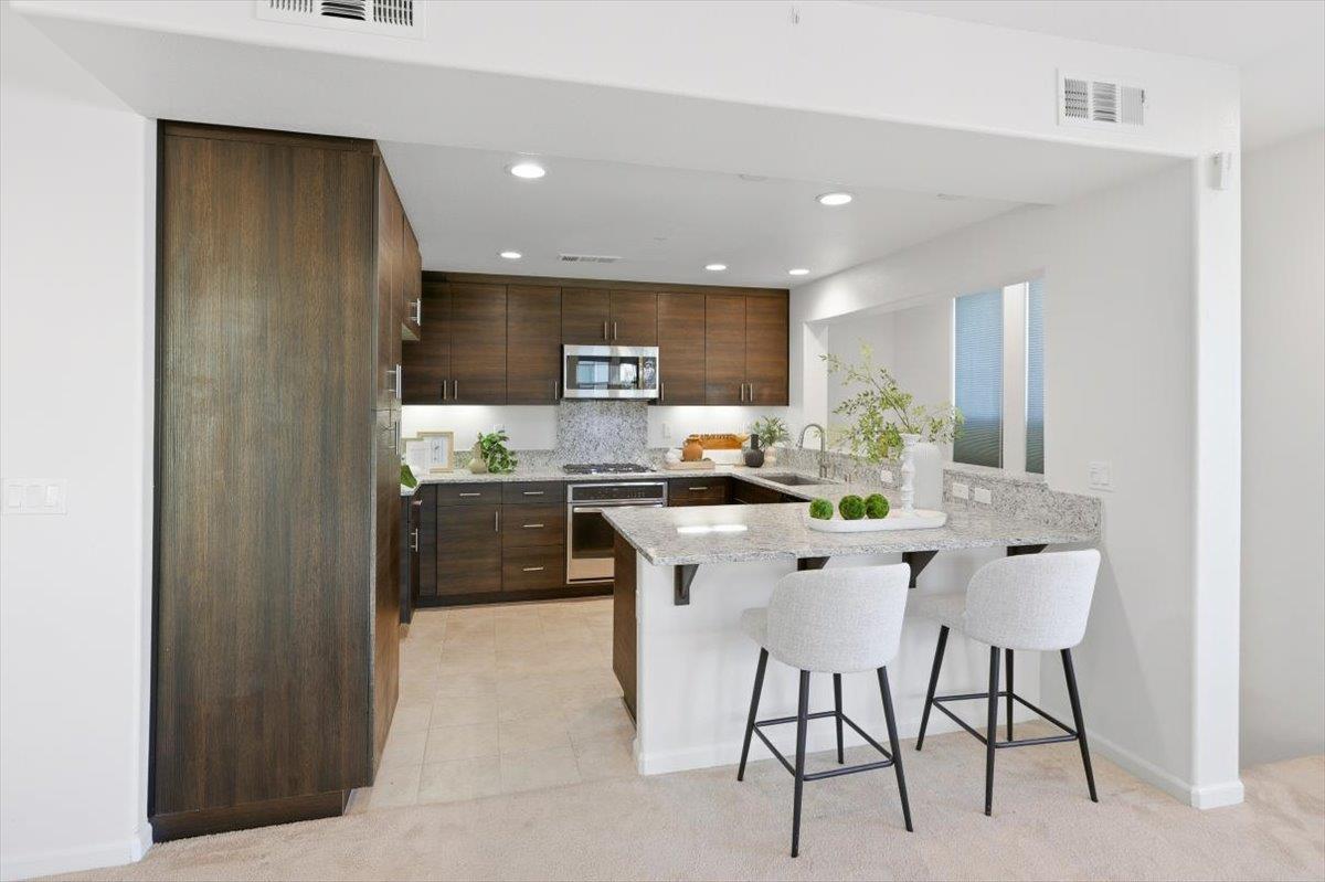 1989 Trento Loop Milpitas, CA 95035 - Photo 6 of 32 a kitchen with a sink and chairs