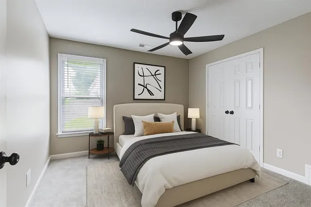 an empty room with closet and a chandelier fan