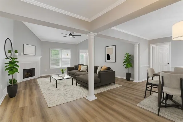 a living room with furniture a fireplace and a table