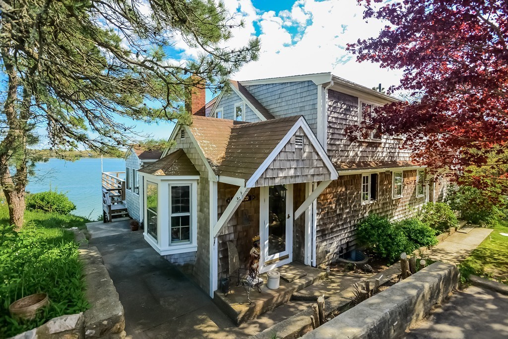front view of a house with a tree