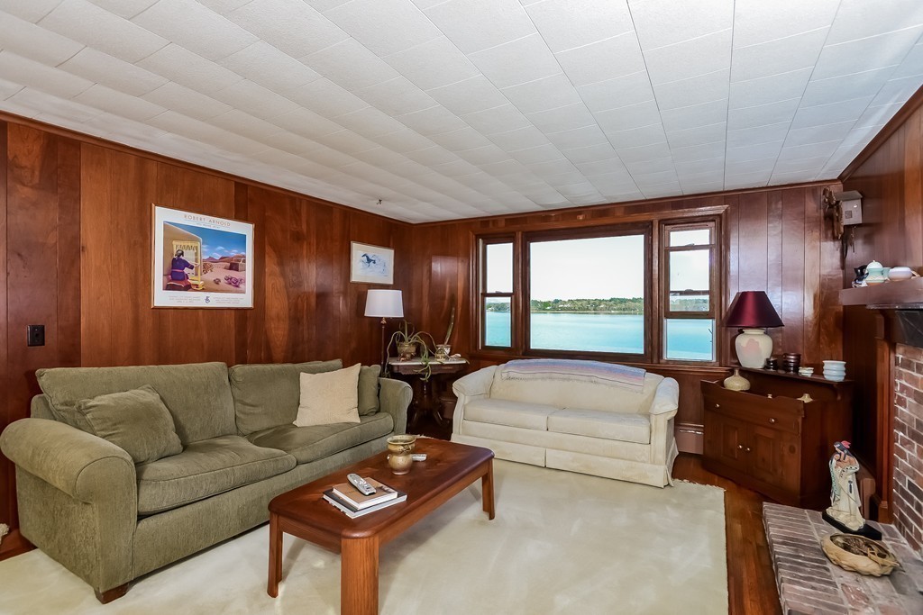 51 Pine Ridge Road Bourne, MA 02532 - Photo 14 of 25 a living room with furniture fireplace and large windows