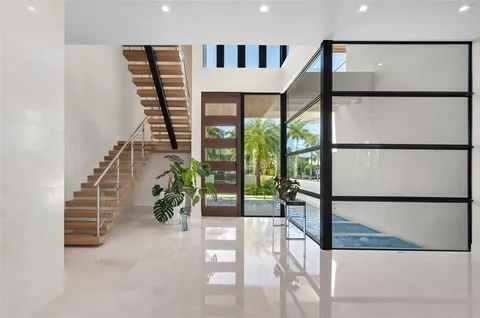 a living room with furniture large windows and a flat screen tv