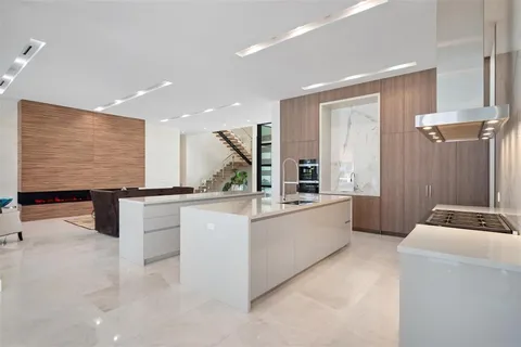 a living room with stainless steel appliances furniture and a fireplace