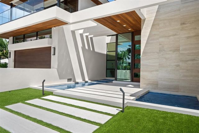 a large white kitchen with a large counter top furniture appliances and a counter top space