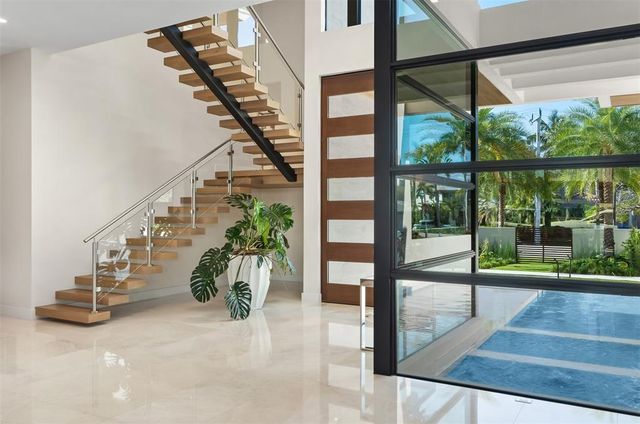 a kitchen with stainless steel appliances a sink and a large window