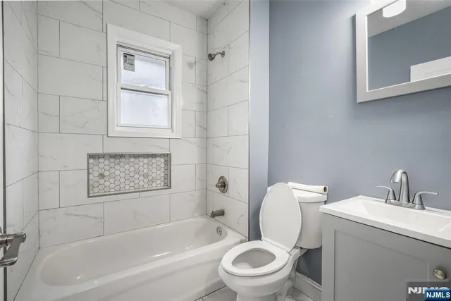 a white toilet sitting next to a bath tub