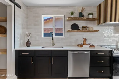 a kitchen with a sink and cabinets