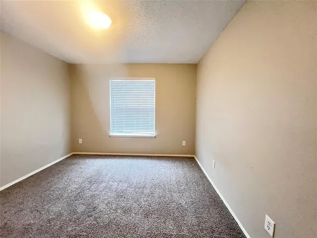 an empty room with a empty space and windows