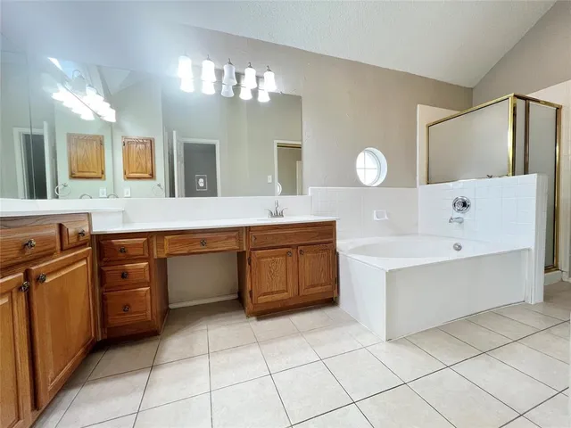a spacious bathroom with a sink a vanity and a mirror