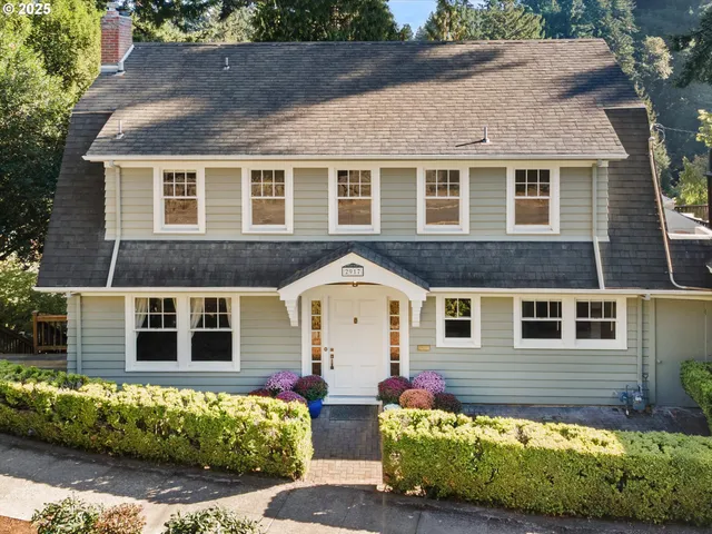 a front view of a house with a garden