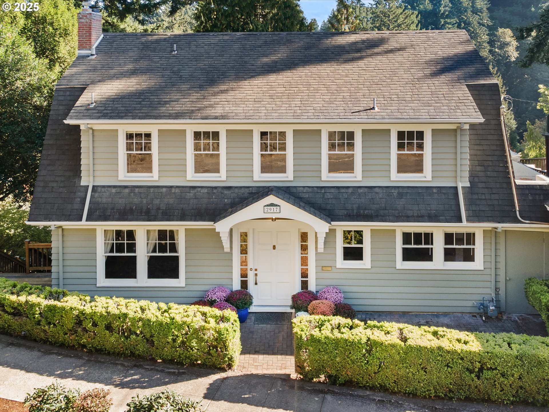 a front view of a house with a garden