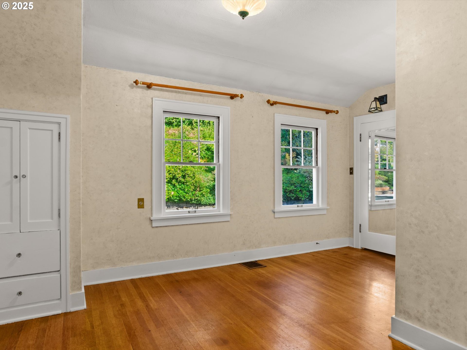 2917 Southwest Fairview Boulevard Portland, OR 97205 - Photo 15 of 25 a view of an empty room with wooden floor and a window