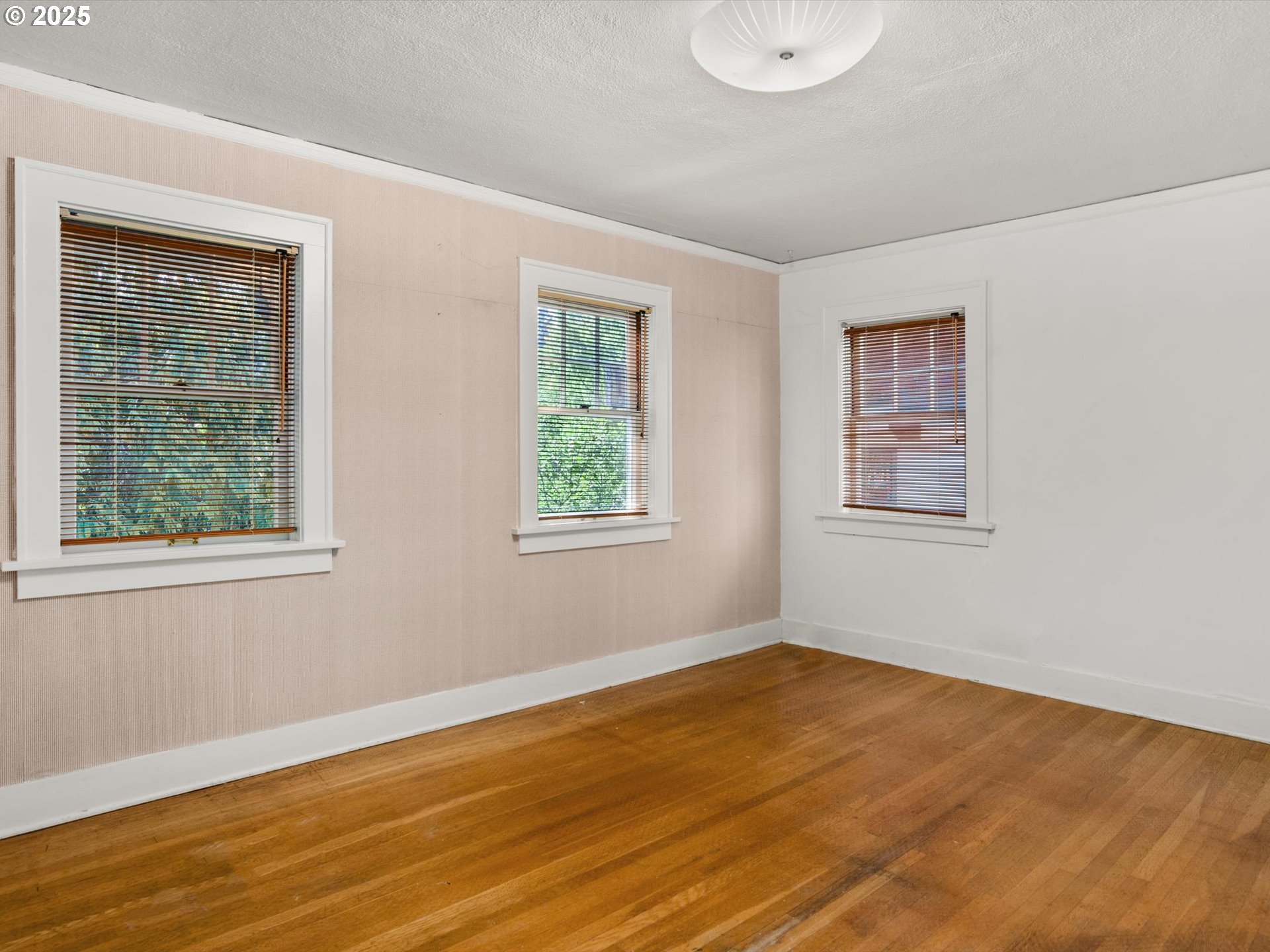 2917 Southwest Fairview Boulevard Portland, OR 97205 - Photo 17 of 25 a view of an empty room with wooden floor and a window