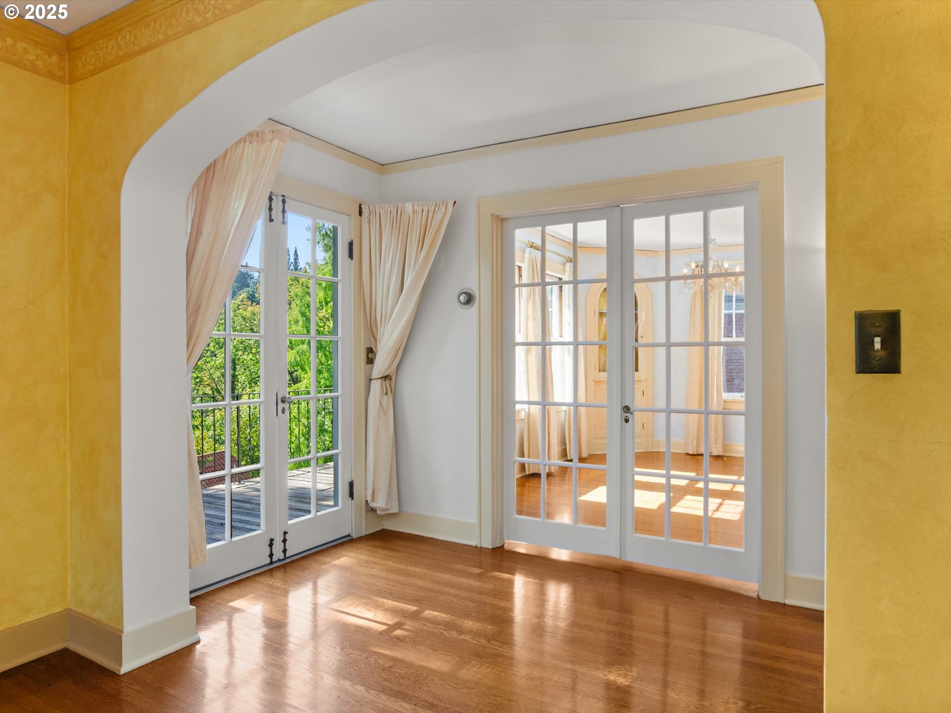 2917 Southwest Fairview Boulevard Portland, OR 97205 - Photo 5 of 25 a view of an empty room with wooden floor and a window