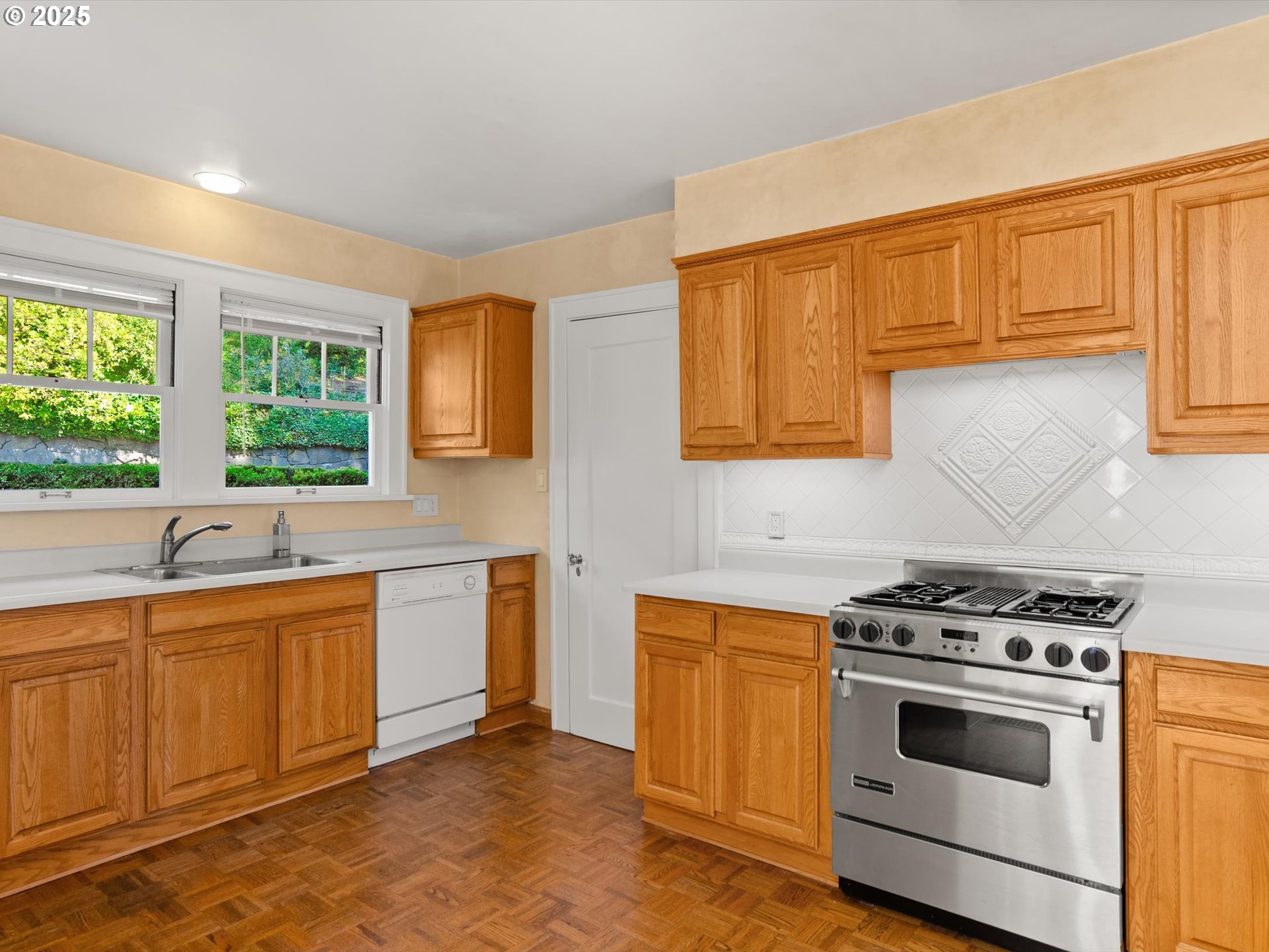 2917 Southwest Fairview Boulevard Portland, OR 97205 - Photo 9 of 25 a kitchen with stainless steel appliances a stove sink and cabinets