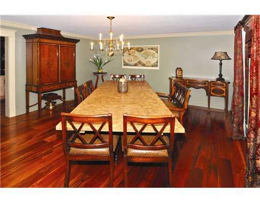 Dining Room. The gracious Dining room, painted in a rich tone of olive, offers the same Tiger wood flooring which is offset by lush custom made molding (throughout the home).
