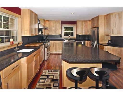 Kitchen. Under cabinet lighting sets the stage in this gourmet kitchen, offering a huge center island, vegetable sink, SS farm sink, double door SS refrigerator, double drawer DW, and top of the line gas stove and warming vent.