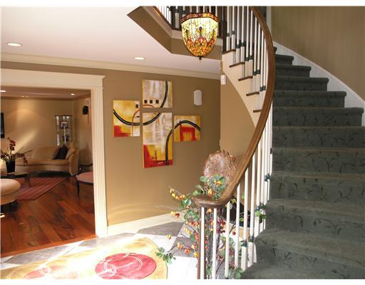 Entry/Foyer. Dramatic curved staircase in entrance hall.