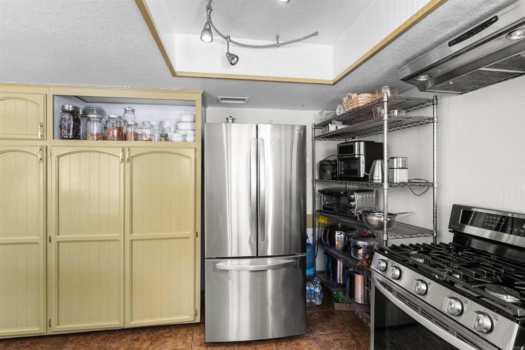 3340 Skytrail Ranch Road Jamul, CA 91935 - Photo 13 of 38 a kitchen with stainless steel appliances granite countertop a refrigerator and a stove