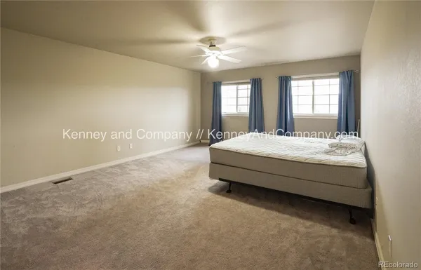 a spacious bathroom with a tub sink and mirror