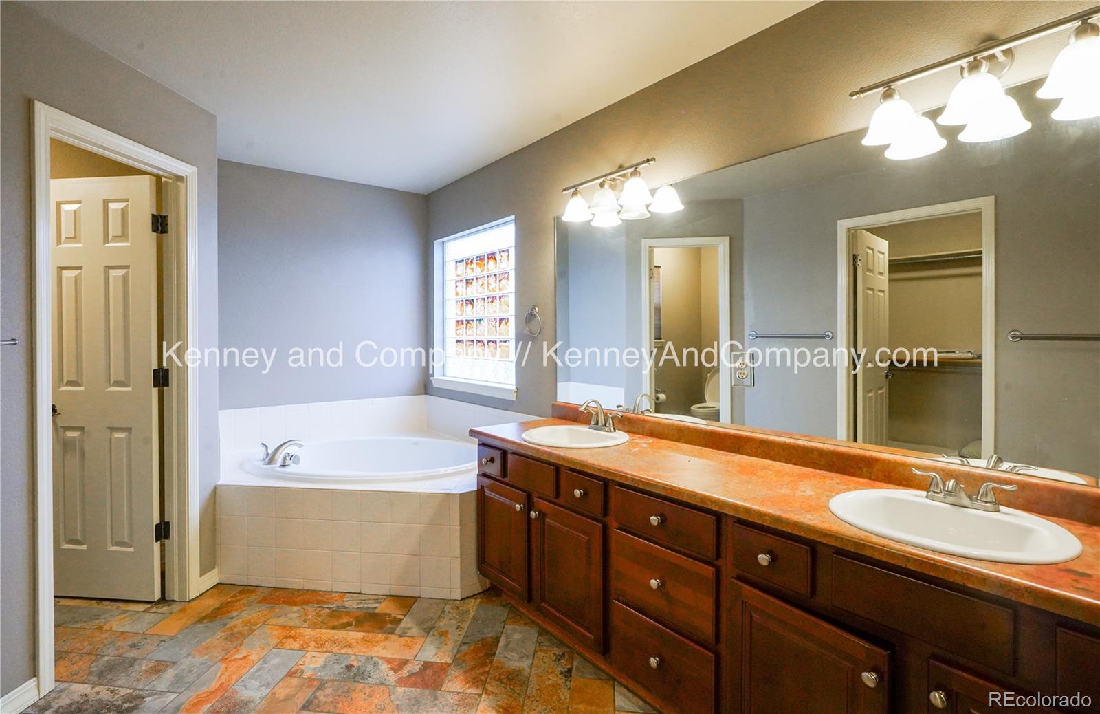 15879 Agate Creek Drive Monument, CO 80132 - Photo 12 of 24 a spacious bathroom with a tub sink and mirror