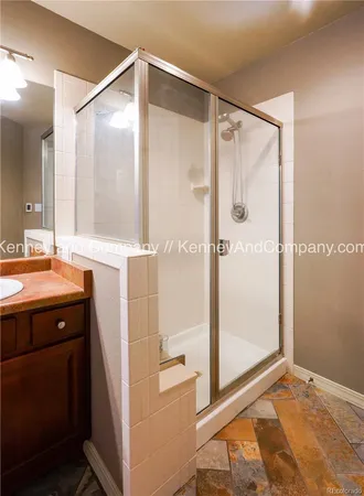 a spacious bathroom with a sink a mirror and a shower