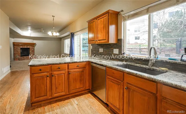 an empty room with windows and fireplace