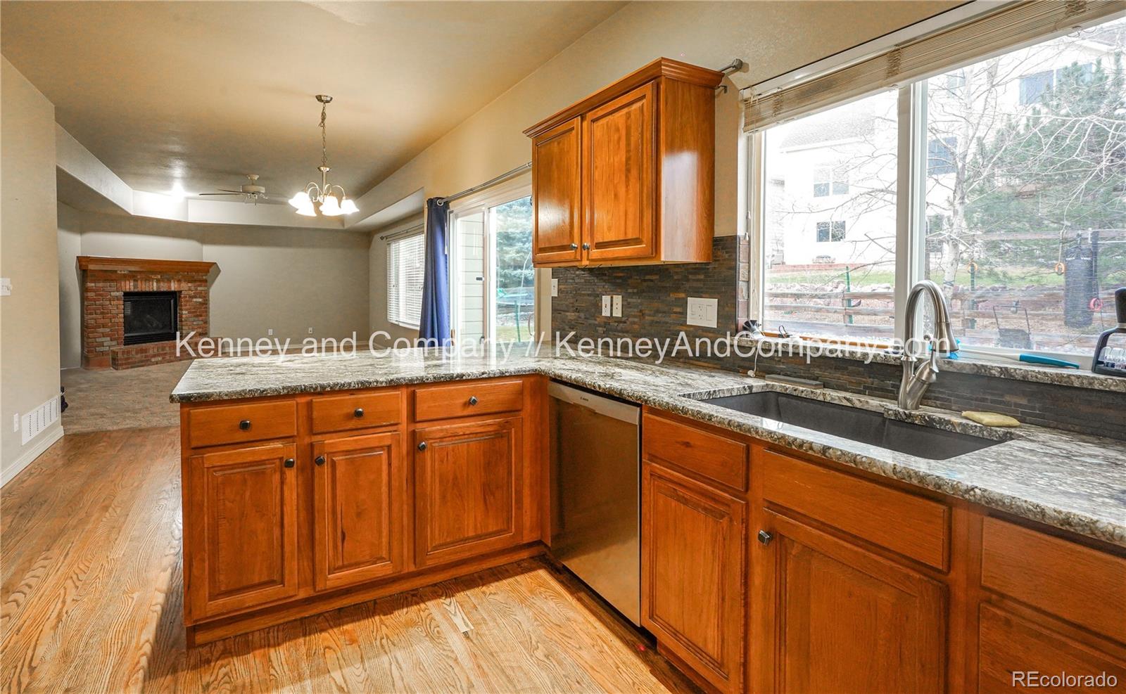 15879 Agate Creek Drive Monument, CO 80132 - Photo 6 of 24 a kitchen with stainless steel appliances granite countertop sink stove and cabinets