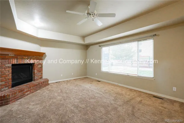 a view of a livingroom with a window and wooden floor