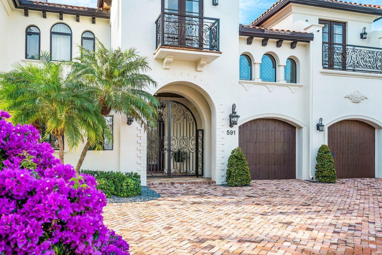591 Phillips Drive Boca Raton, FL 33432 - Photo 12 of 90 a front view of a house with garden