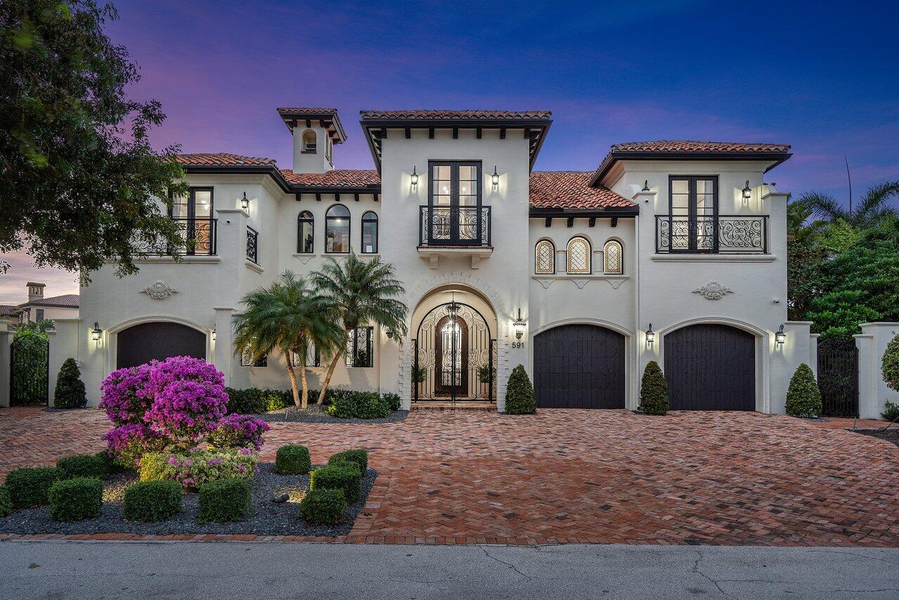 591 Phillips Drive Boca Raton, FL 33432 - Photo 2 of 90 a front view of a house with a yard