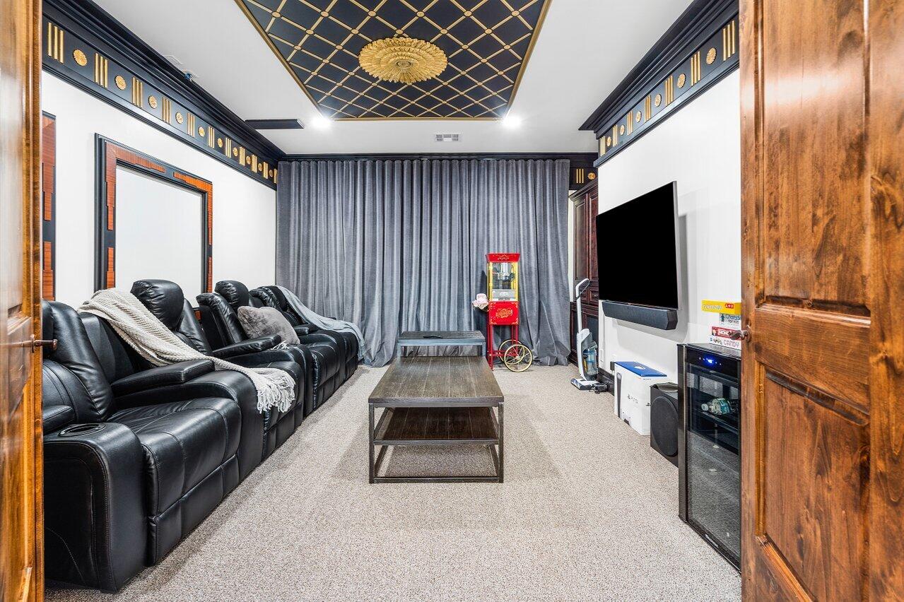 591 Phillips Drive Boca Raton, FL 33432 - Photo 48 of 90 a living room with furniture and a flat screen tv