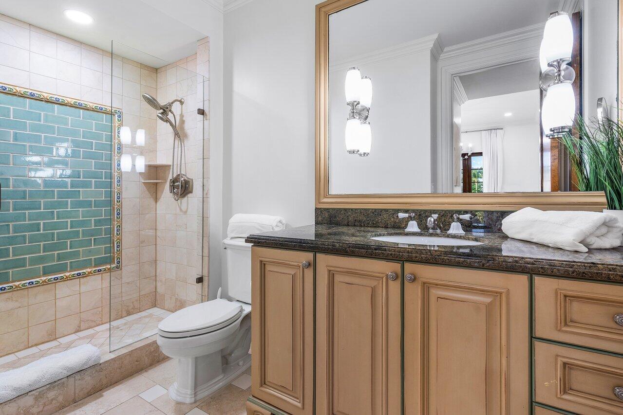 591 Phillips Drive Boca Raton, FL 33432 - Photo 50 of 90 a bathroom with a granite countertop sink a toilet and shower