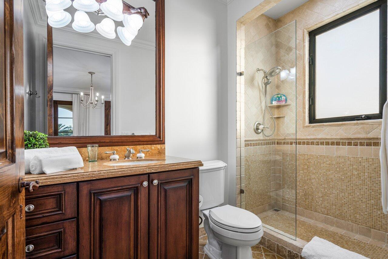 591 Phillips Drive Boca Raton, FL 33432 - Photo 51 of 90 a bathroom with a granite countertop sink toilet and mirror