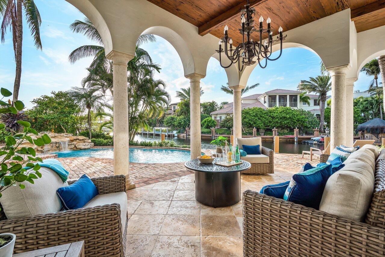 591 Phillips Drive Boca Raton, FL 33432 - Photo 58 of 90 a view of a patio with couches chairs and potted plants
