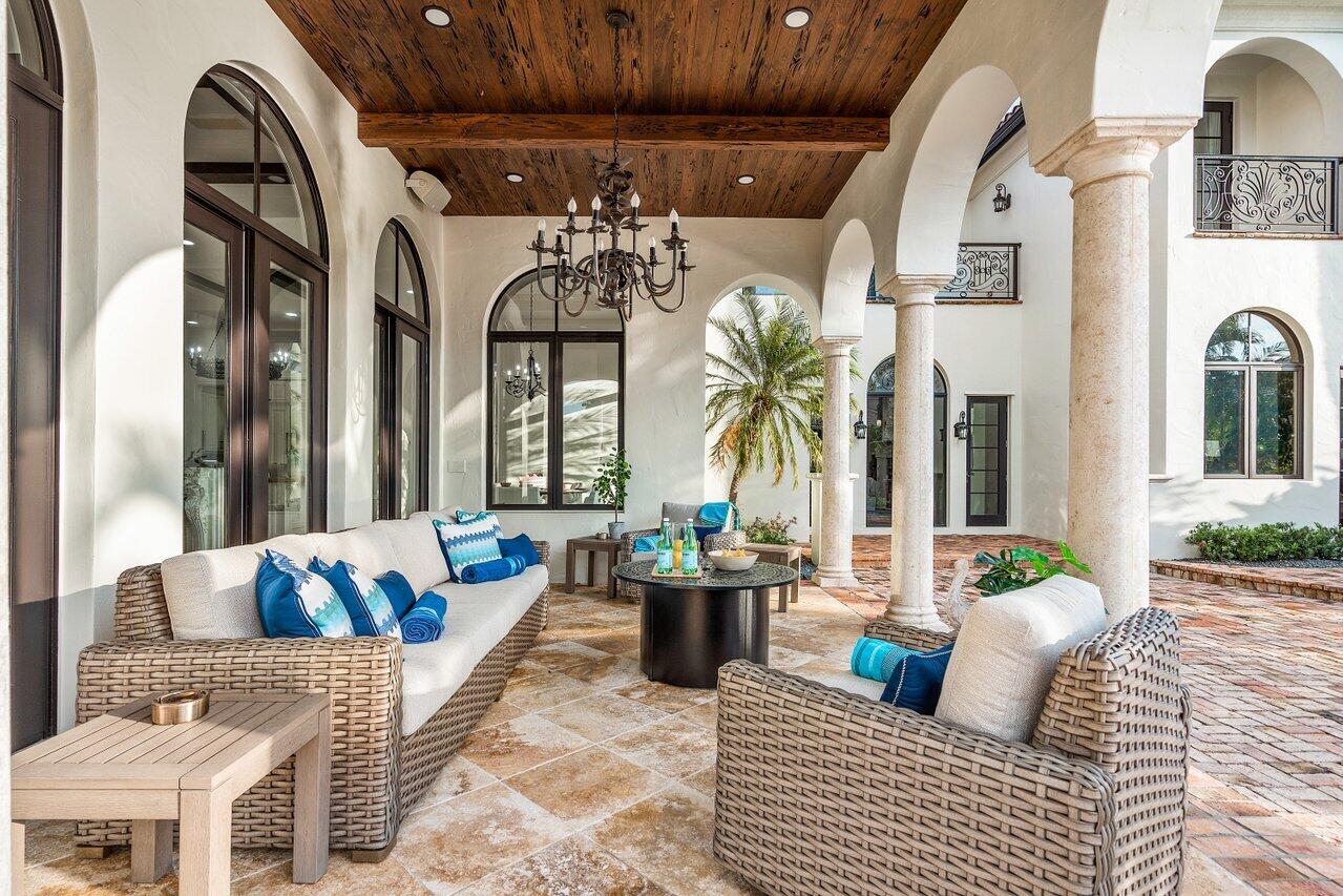 591 Phillips Drive Boca Raton, FL 33432 - Photo 59 of 90 a view of living room filled with furniture and a chandelier