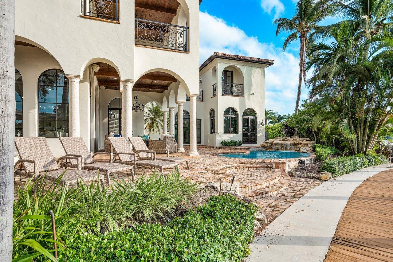 591 Phillips Drive Boca Raton, FL 33432 - Photo 61 of 90 a front view of a house with garden