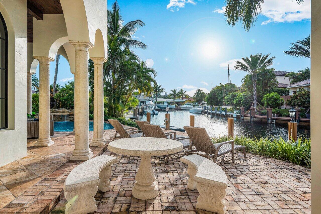 591 Phillips Drive Boca Raton, FL 33432 - Photo 63 of 90 a view of a lake with patio