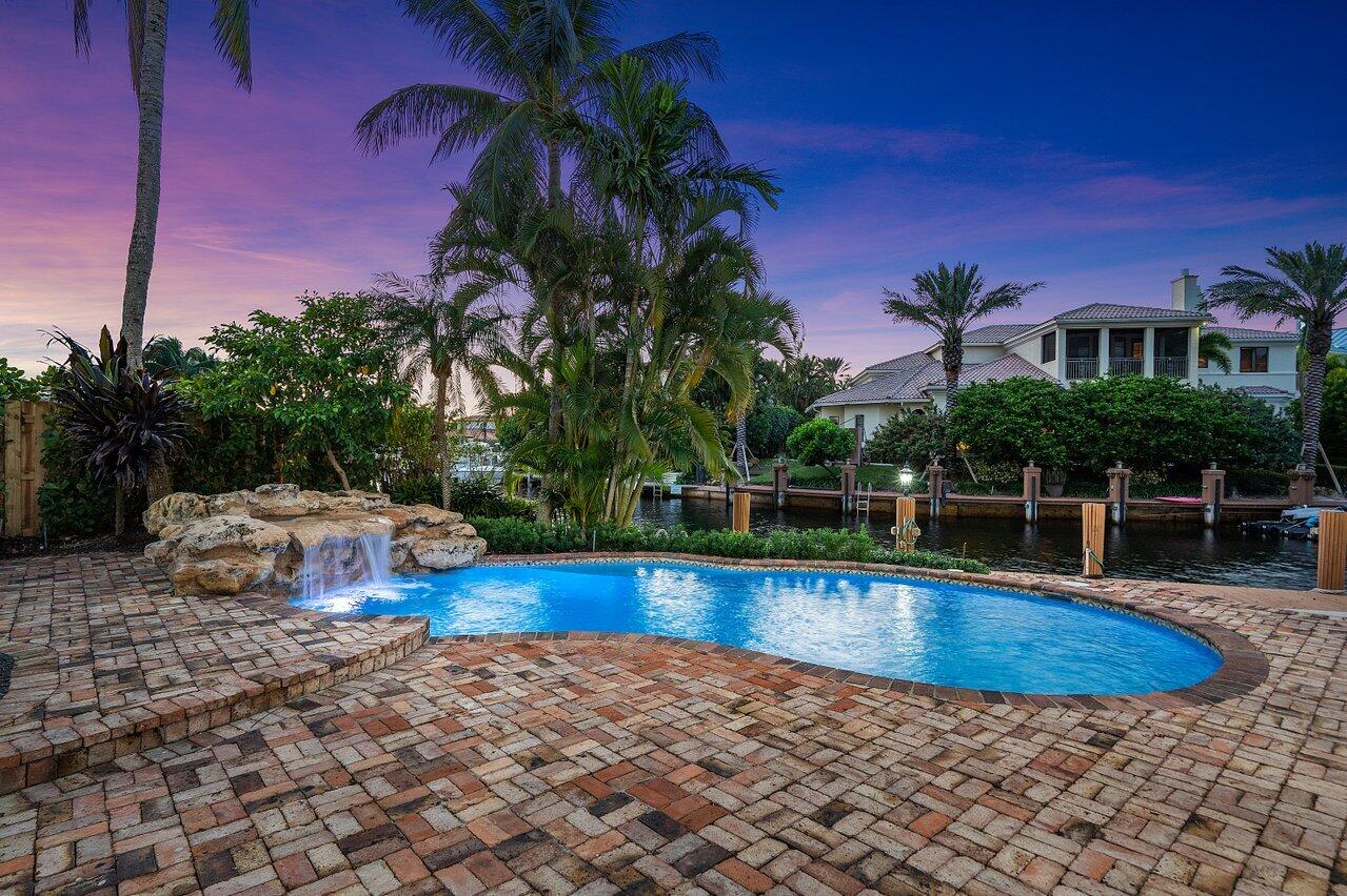 591 Phillips Drive Boca Raton, FL 33432 - Photo 73 of 90 a view of a swimming pool with an outdoor space
