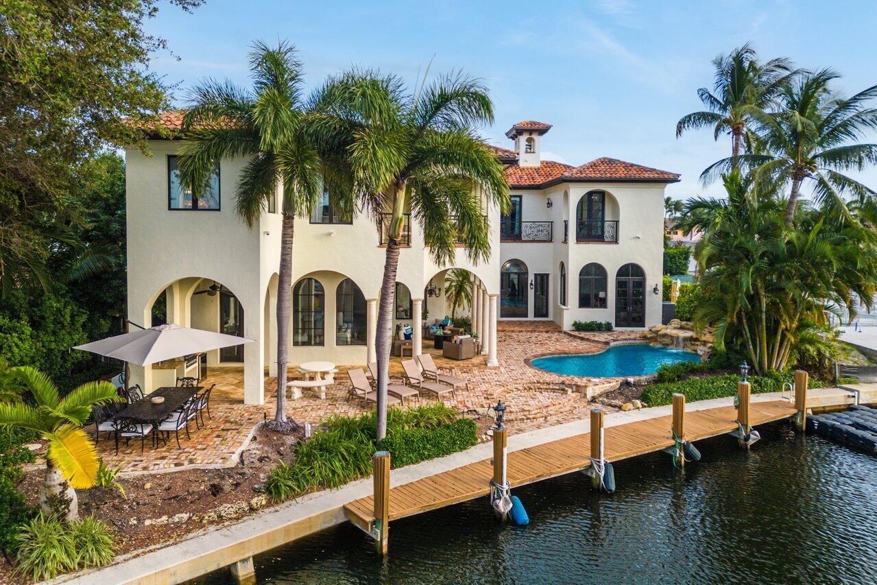 591 Phillips Drive Boca Raton, FL 33432 - Photo 8 of 90 a front view of house with yard and outdoor seating
