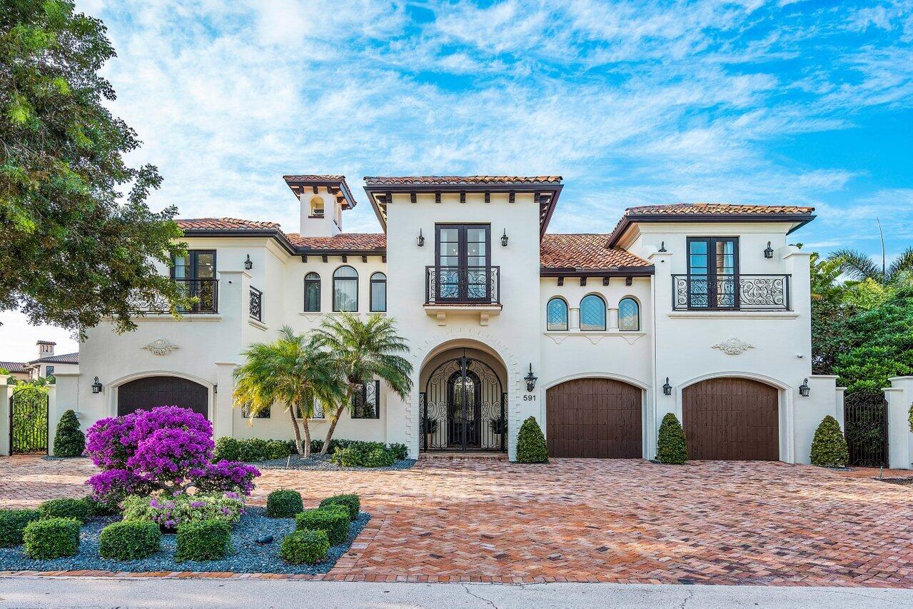 591 Phillips Drive Boca Raton, FL 33432 - Photo 10 of 90 a front view of a house with garden