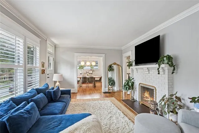 a living room with furniture a fireplace and a flat screen tv
