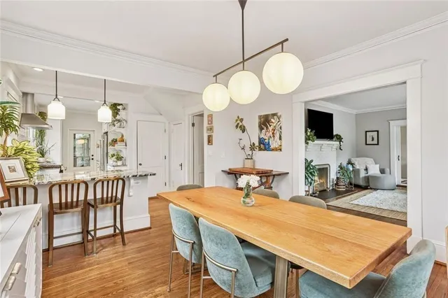 a view of a dining room and hall with wooden floor