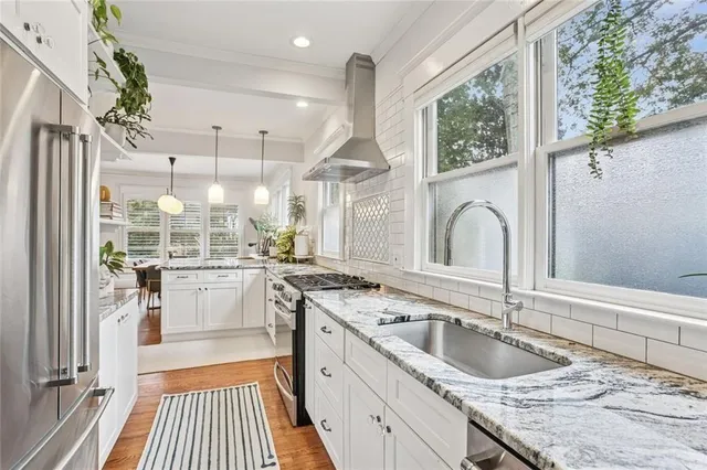 a kitchen with a sink a counter top space and stainless steel appliances
