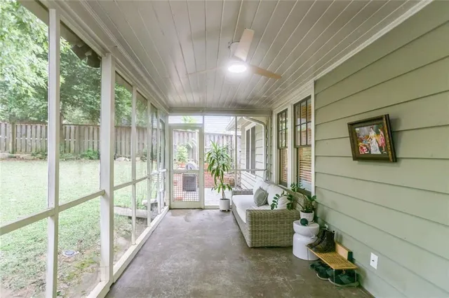 a living room with furniture and a floor to ceiling window