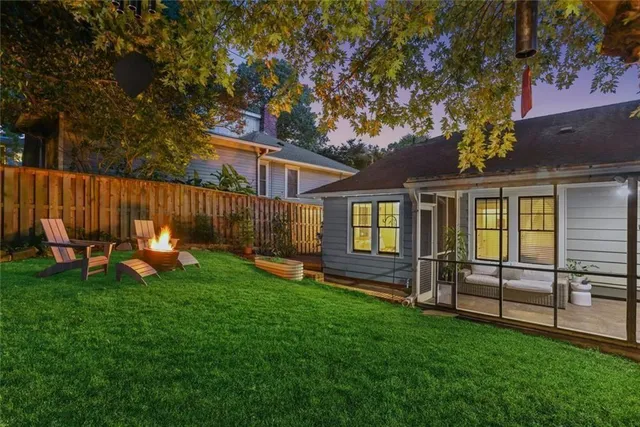 a view of a house with backyard and a tree