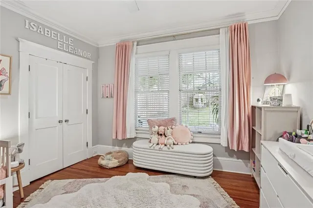 a bedroom with a bed and large windows